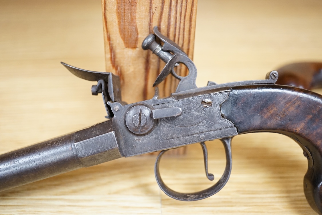 A double barrel flintlock, tap action pocket pistol by Collis of Oxford, with sliding top thumb safety, slab walnut grip, and tower private proof marks